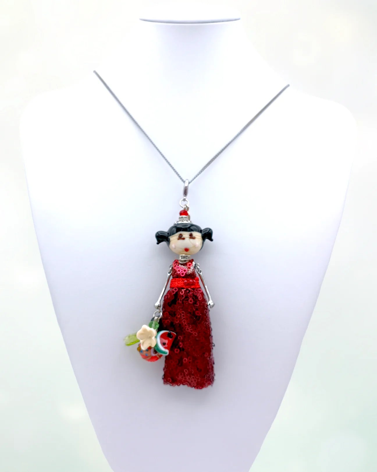 Doll with glass head and glass bouquet necklace